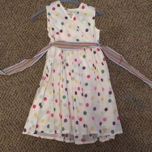 White dress with poke dots and ribbon around waste